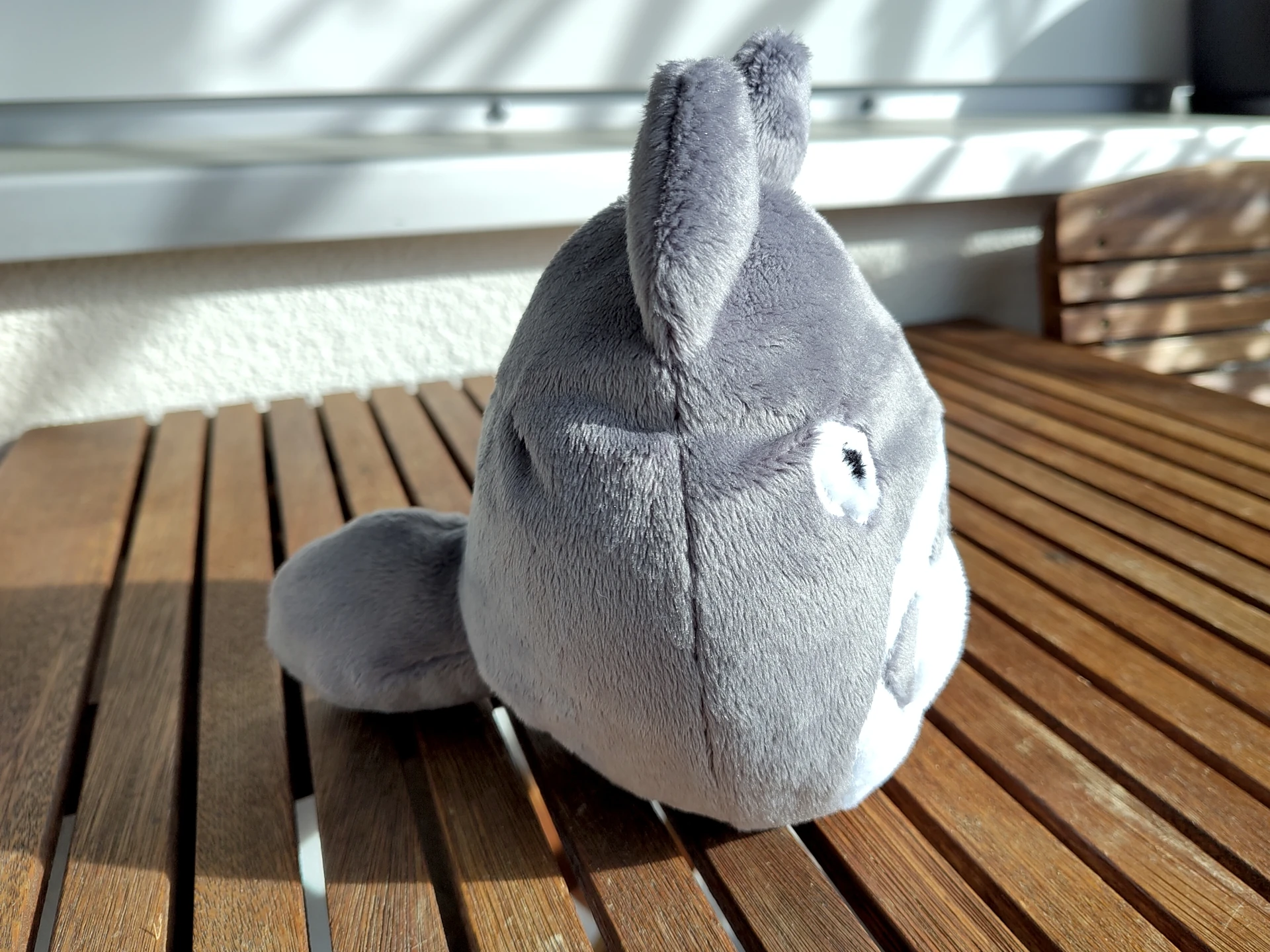The same plushie seen from the side to reveal a short but fluffy tail.